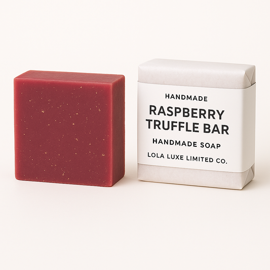 Red raspberry truffle soap bar next to its white box on a white background