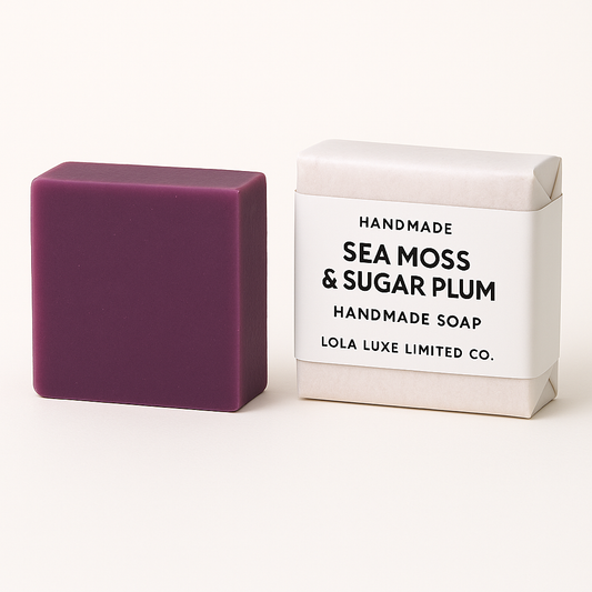 Purple handmade soap bar next to its packaging box on a white background